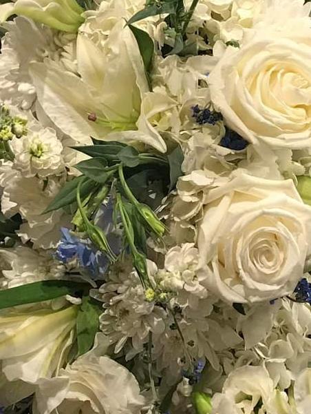White Roses Sprayed Blue White Blue Standing Spray - Funeral Flowers Demotte